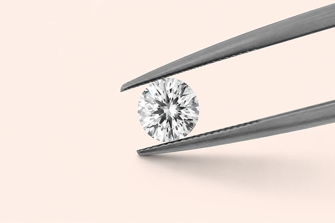 Diamond held with jeweler's tweezers