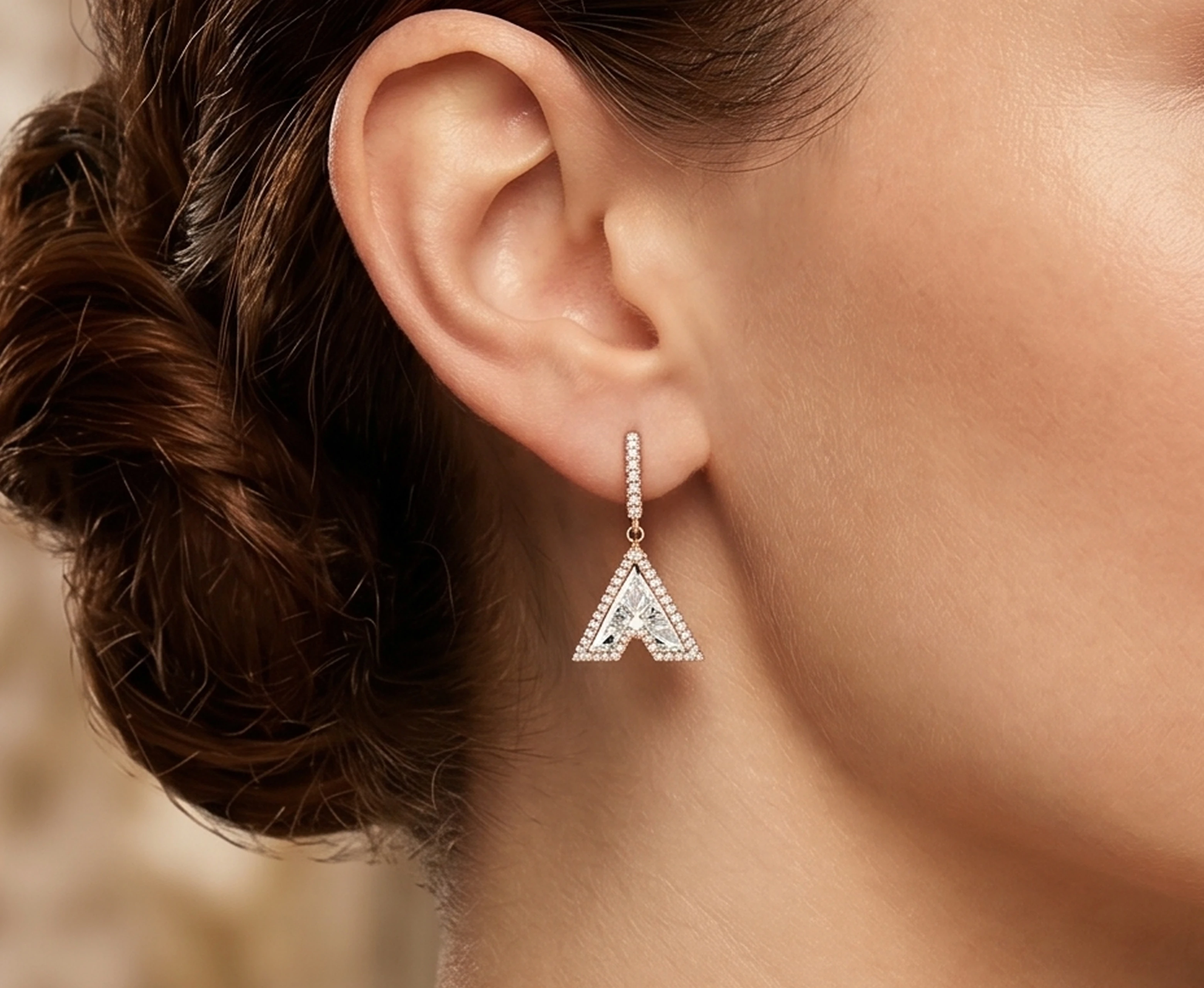Ear wearing a diamond letter drop earring