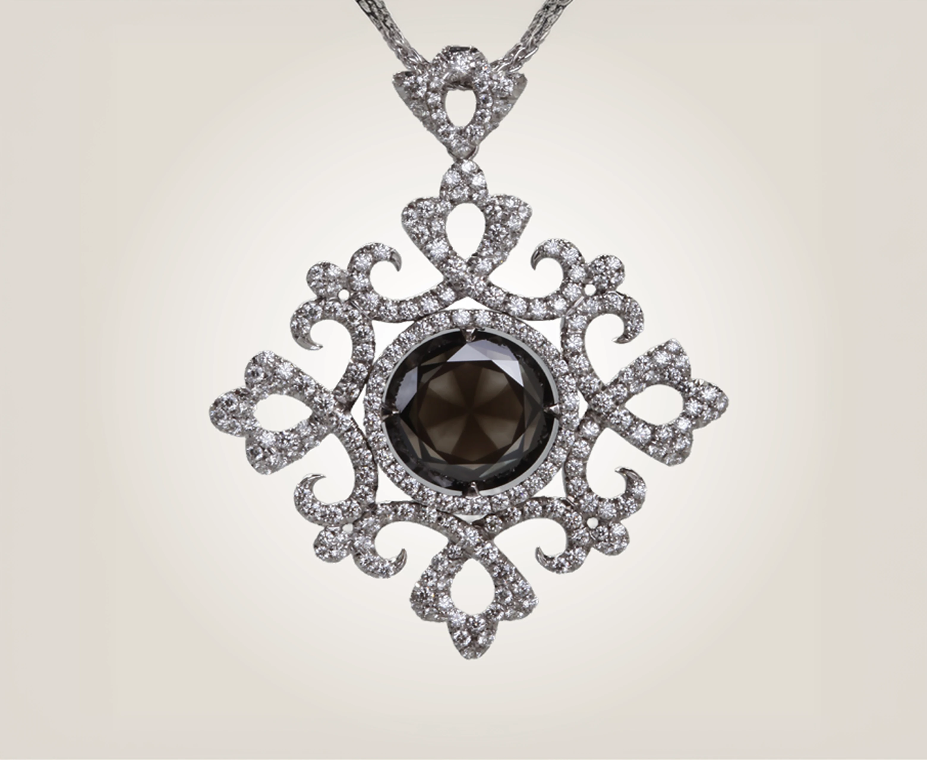 Diamond pendant with a dark center stone and scrolling openwork