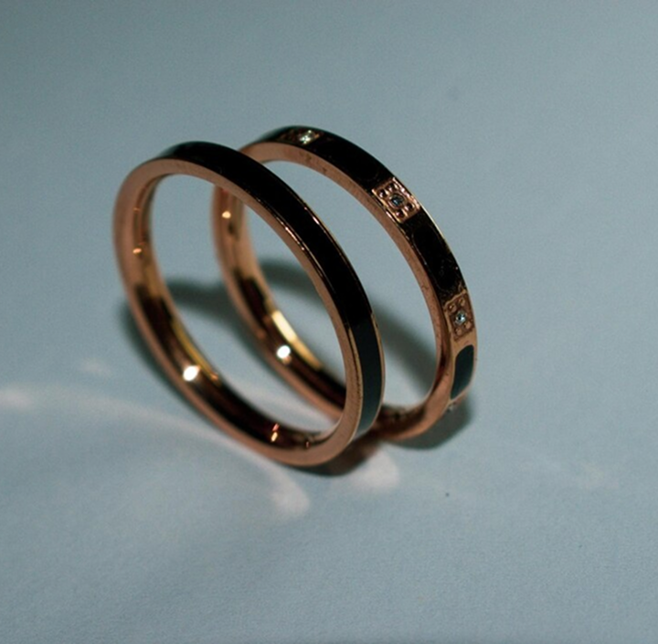Rose gold wedding bands with black enamel details